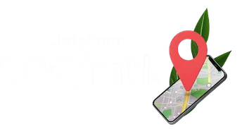 A smartphone displays a map with a red location pin indicating a specific spot. Green grass is in the background.